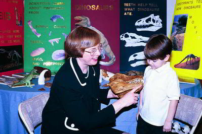 Janet showing dino teeth at library visit