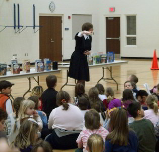 Janet with kids at school visit